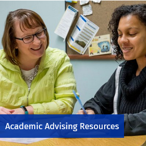 Academic advisor meeting with a student.  Access Academic Advising information.