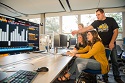 Students looking at a computer monitor in e-Trading lab.