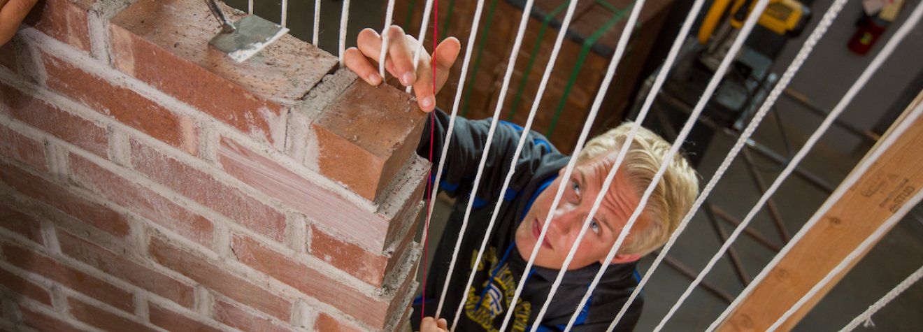 Architecture student building a wall.