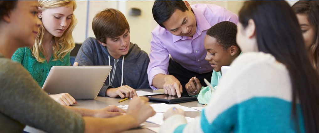 Teacher working with students.