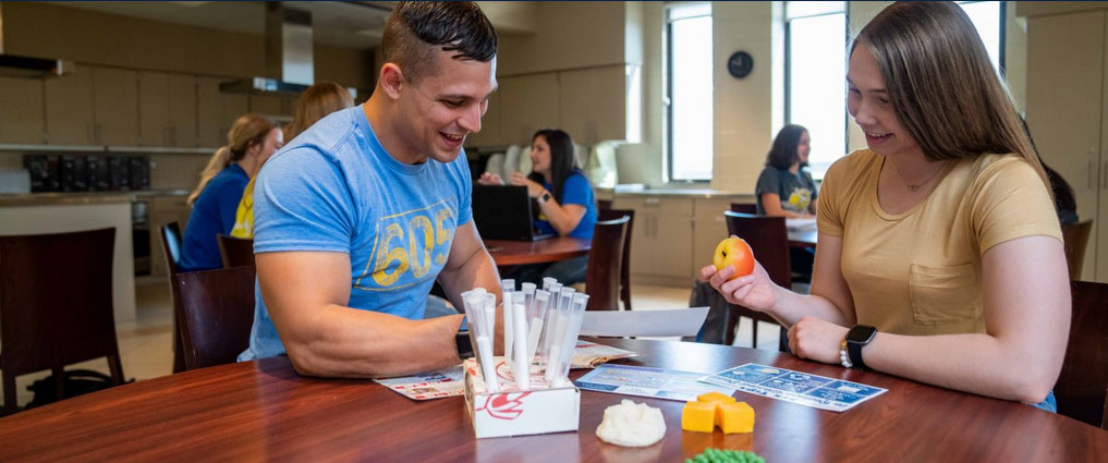 Two students looking at food models