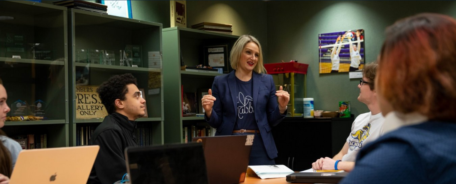 Students and faculty member in a classroom.