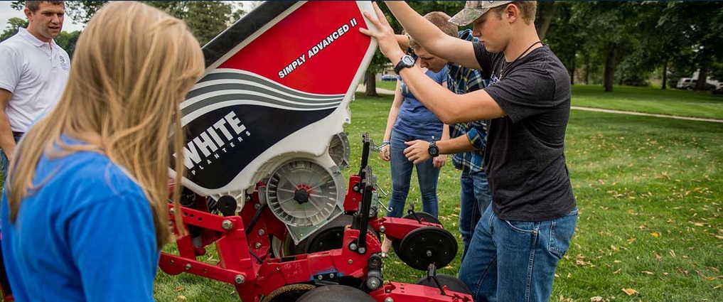 Students next to equipment.