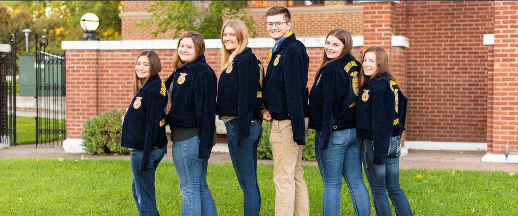 Students standing in a group showing their FFA jackets.