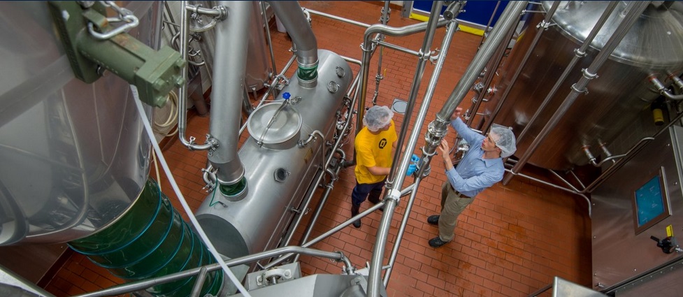 View equipment and two workers inside the Davis Dairy Plant.