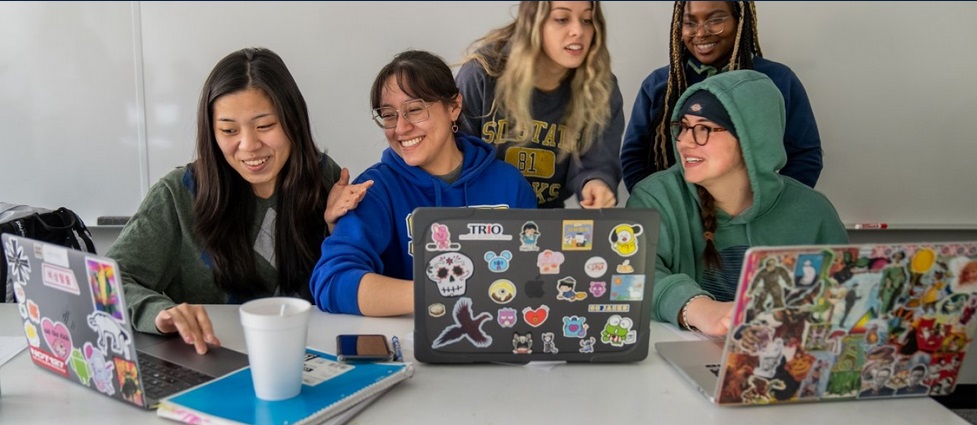 Five students looking at their computers.