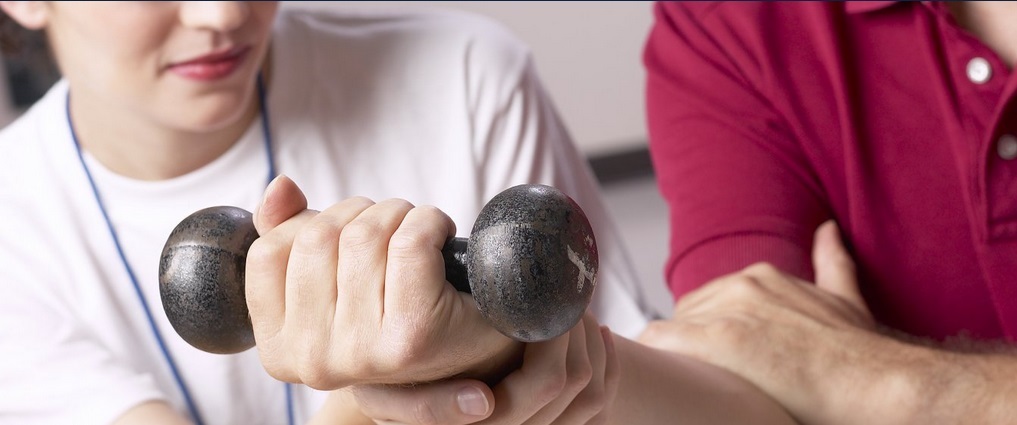 Student holding a hand weight.