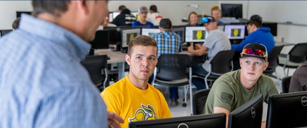 Instructor and students in a precision ag classroom.