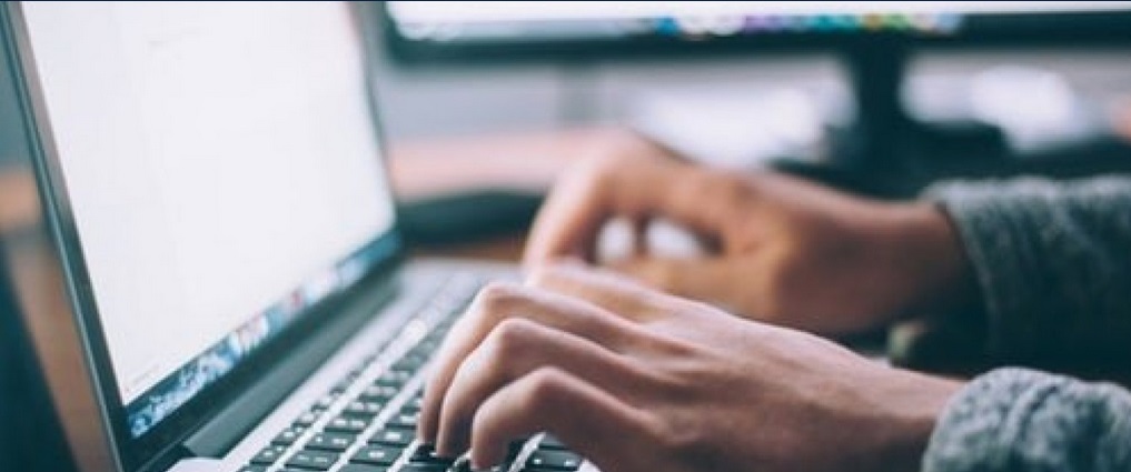 Student typing on a laptop.