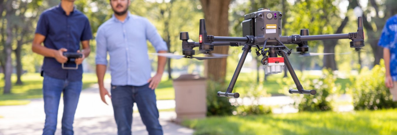 Student and instructor flying a drone.