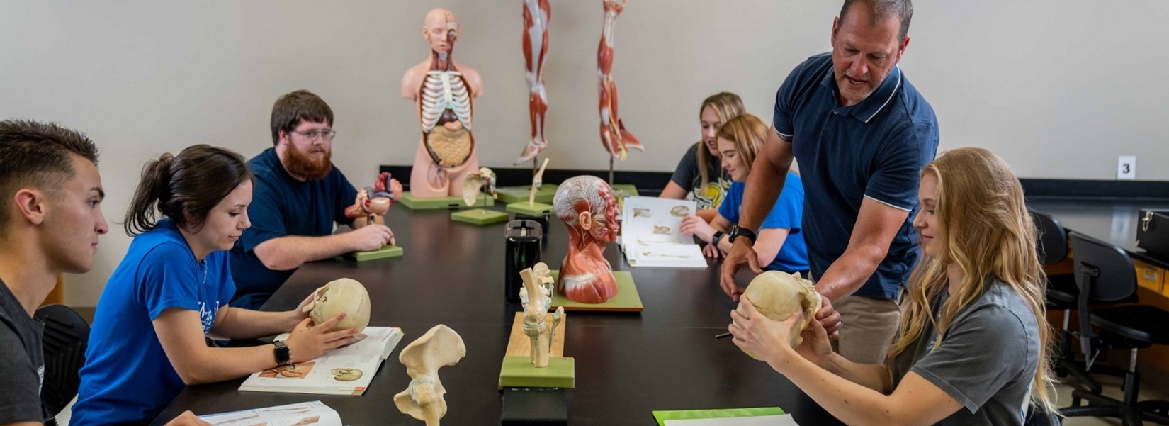 Students and instructor in a biology lab.