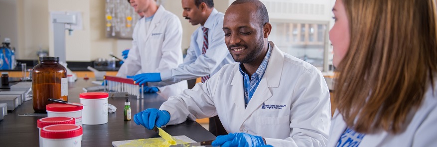 View of pharmacy students working in a lab.