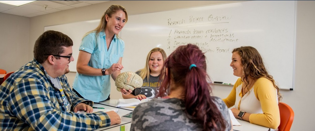 Students and faculty in a classroom.