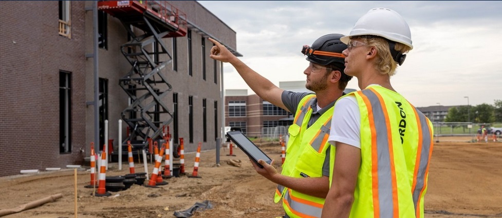 Two individuals looking at a construction jobsite.