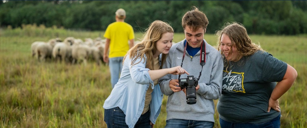 Students looking at a camera