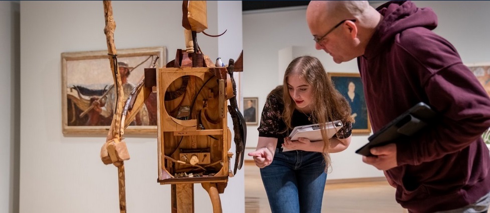 Students looking at a display in the Art Museum.