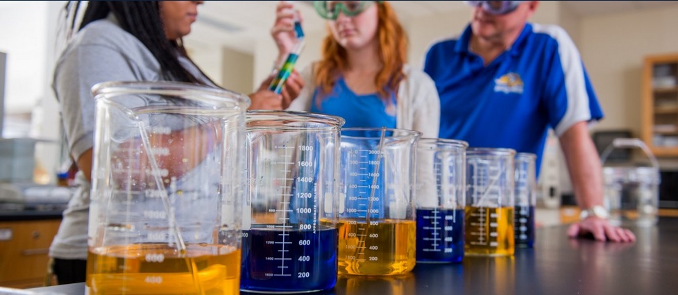 Students and professor working in a lab.