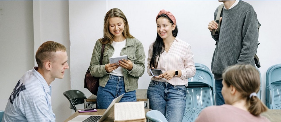 Students talking in a classroom.