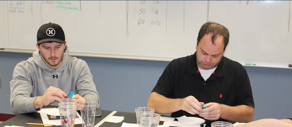 Two students sitting in a class.