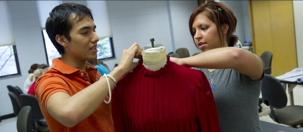 Two students in class working with a top. 