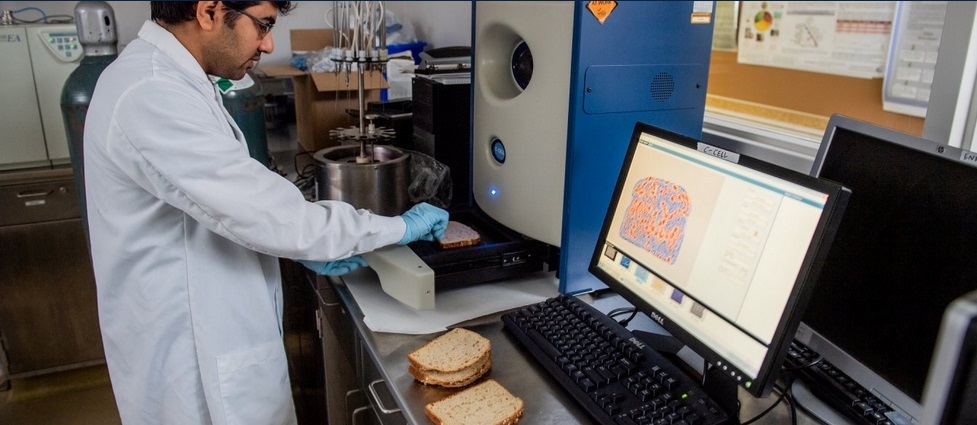 View of student in a lab testing bread.