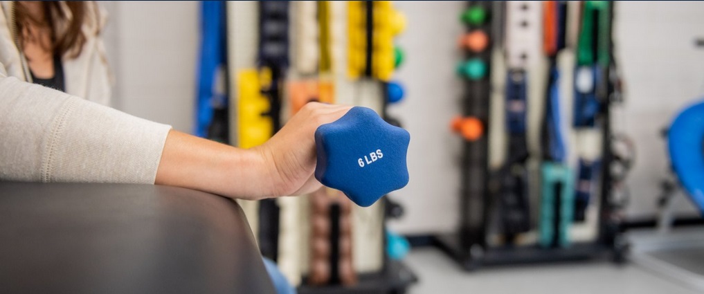 Student holding a hand weight.