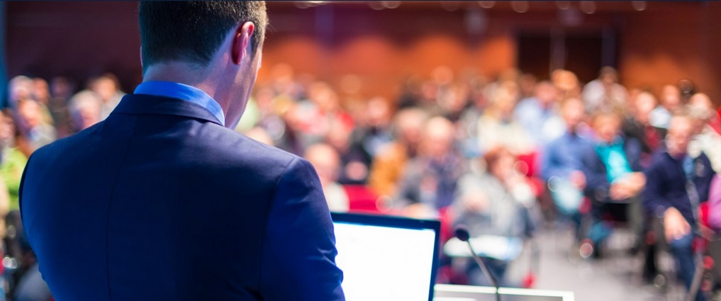 Person presenting to a large group.