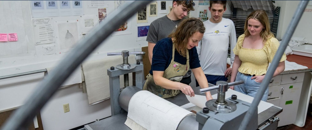 Student and instructor in printmaking lab.