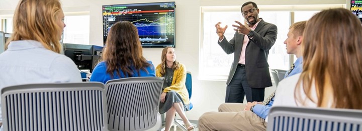 Professor and students in a finance lab.