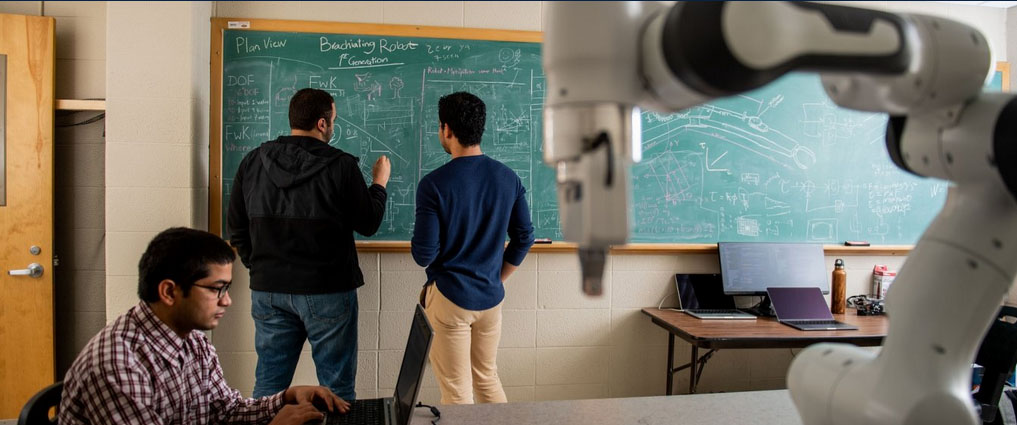 Students writing equations on a chalk board.