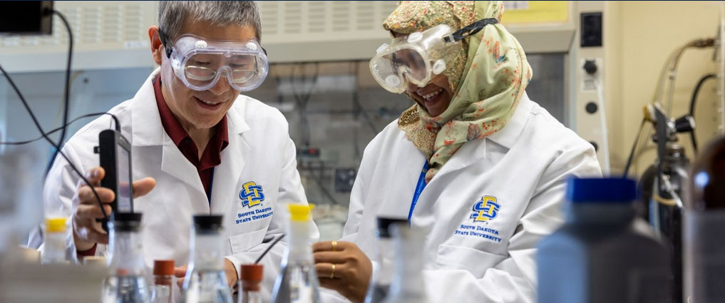 Instructor and student working in a lab.