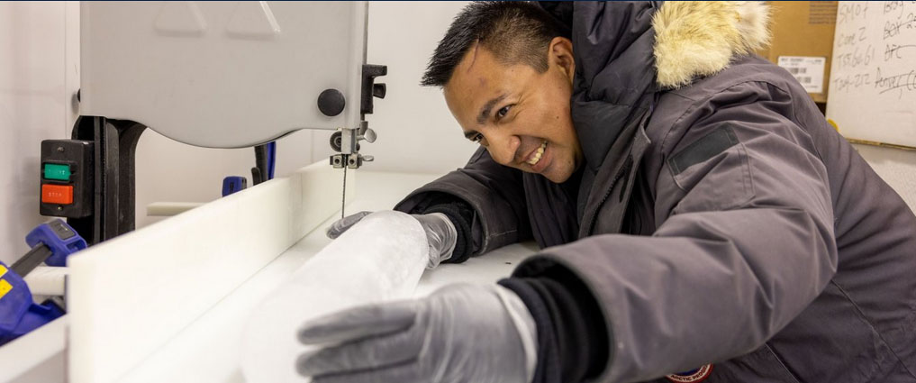 Student working in a lab with ice.