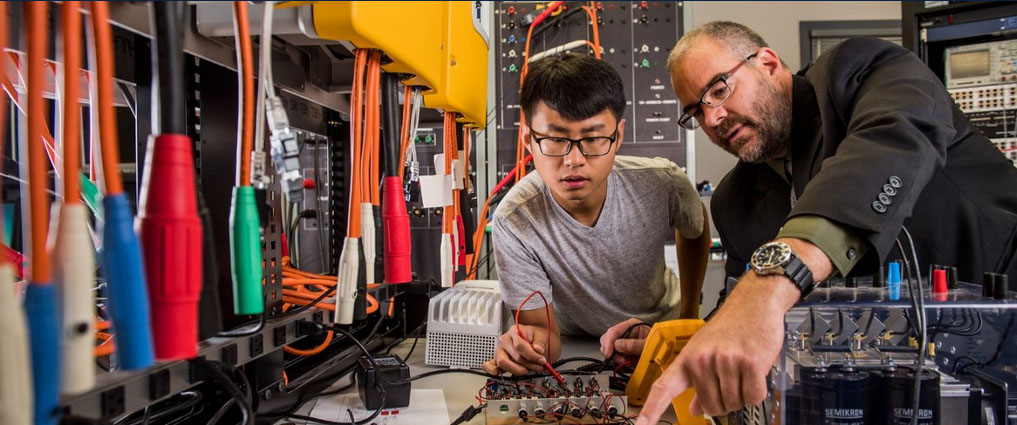 Professor and student working in a lab.