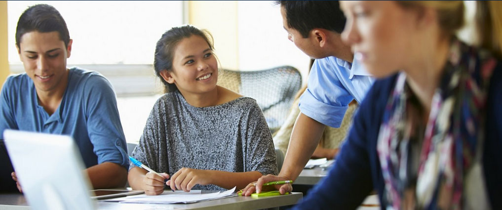 Teacher working with young students.