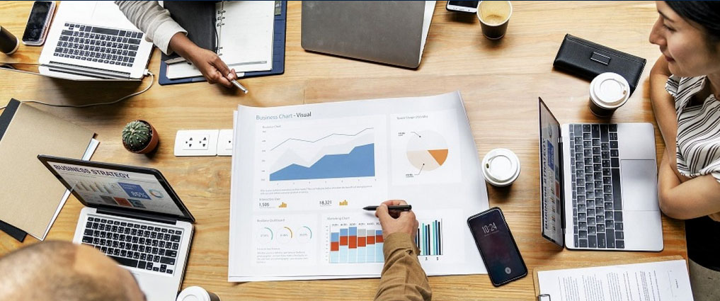 View of a table with a group looking at charts.