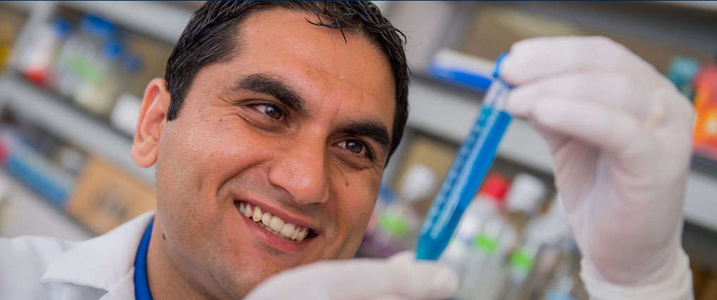 Nutrigenomics student measuring with test tube.