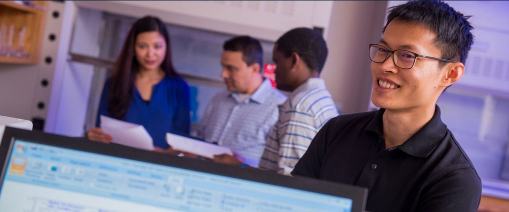 Instructor and students in a lab.