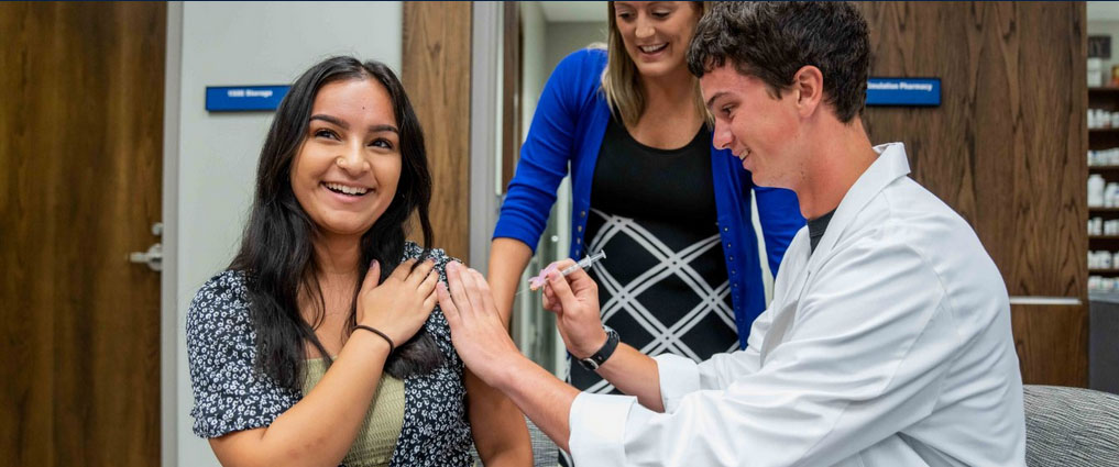 Student practicing giving an injection.