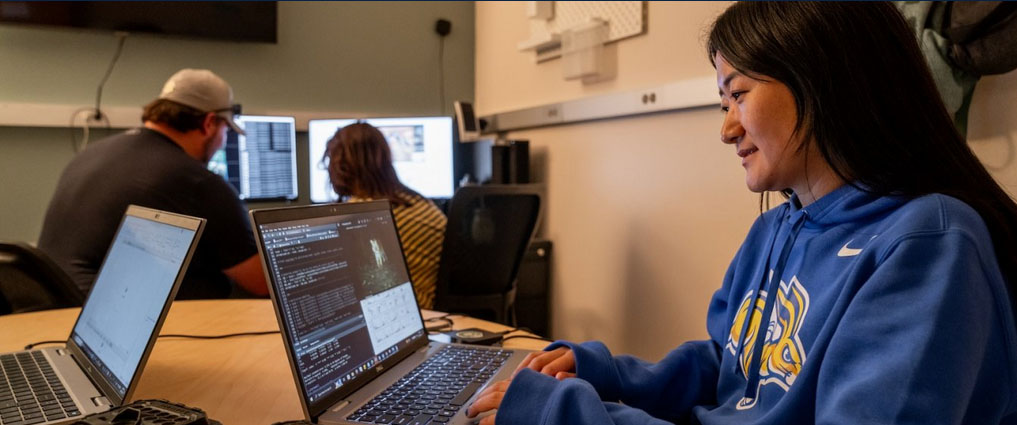 Student looking at data on a computer screen.