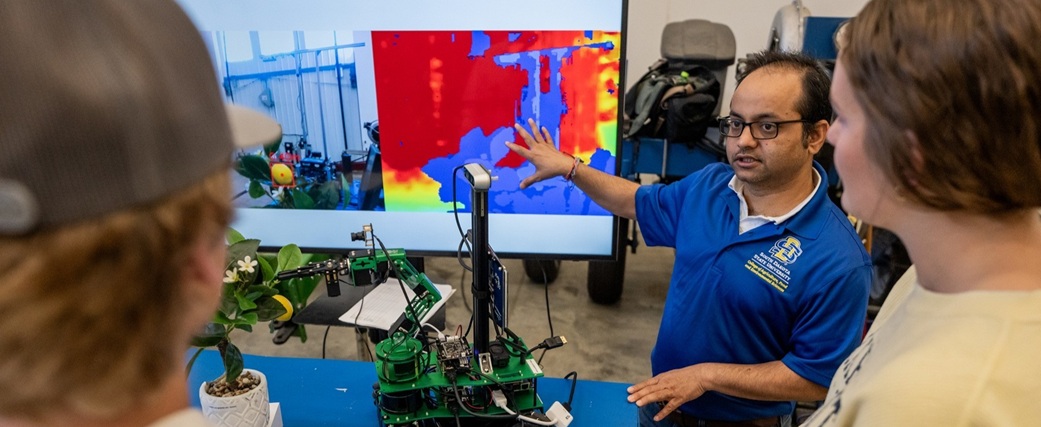 Two students listening to their instructor.