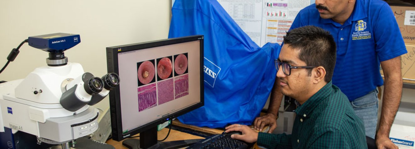 Student and instructor working in a lab.