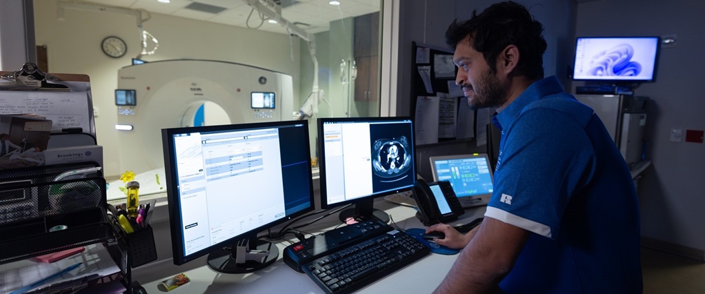 Student working with equipment in a hospital.