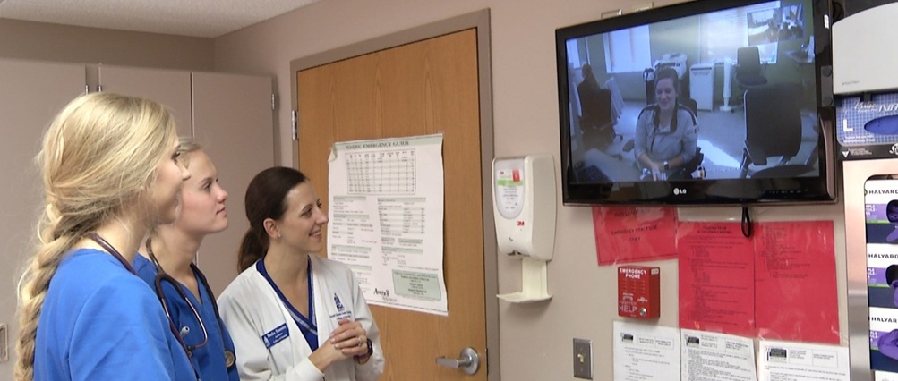 Two students and an instructor engage in a telehealth session.