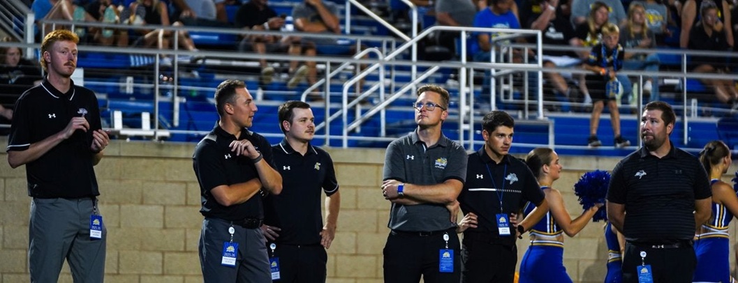 Sport Managers on sideline of a Jackrabbit football game 