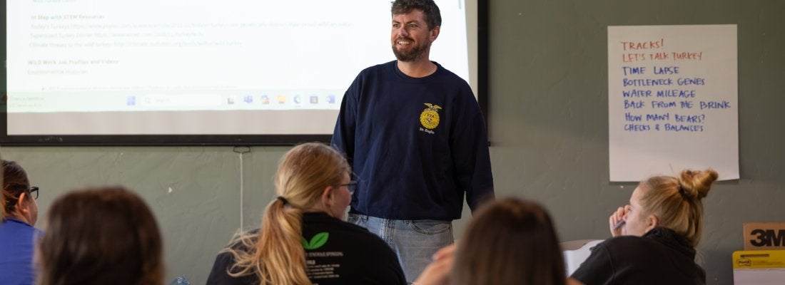 Teacher standing in front of a classroom.